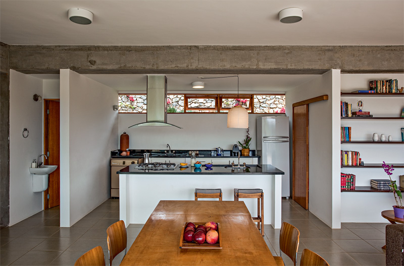 Quando chove e o terreno não pode ser usado, as refeições são feitas na sala de jantar integrada à cozinha. Toda a área recebeu porcelanato da Portobello. Projeto de Carlos Ferrata.