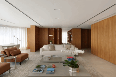 A madeira guia o projeto e esconde espaços neste apê de 410 m²