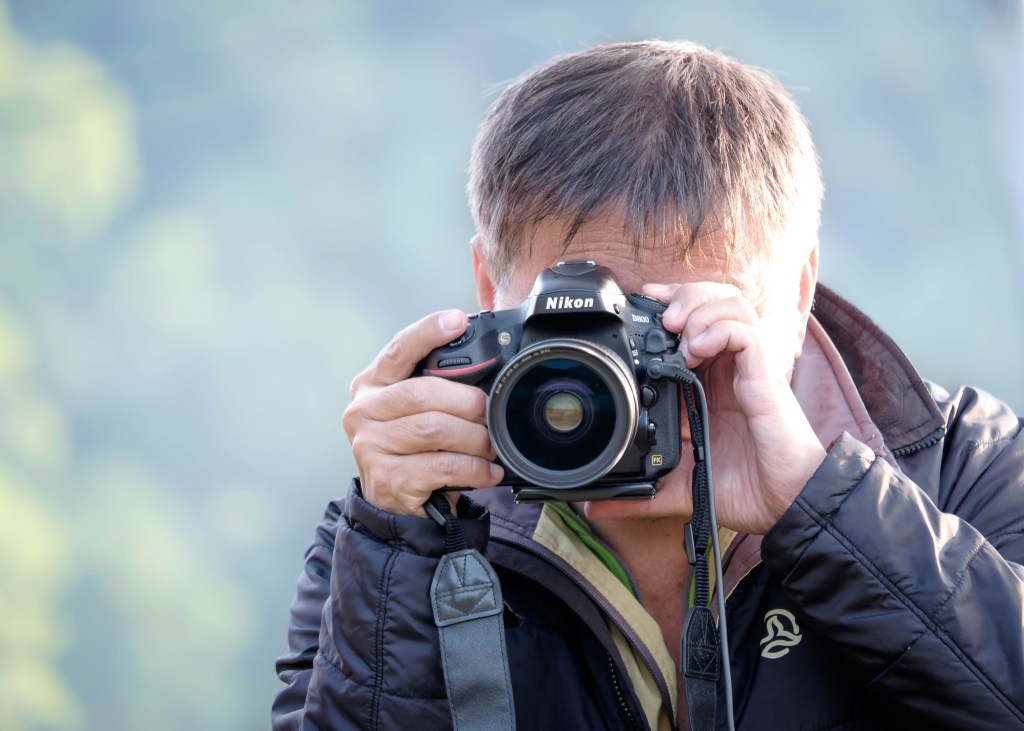 A photographer shooting with DSLR camera